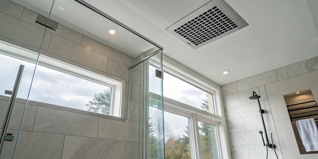 A modern bathroom wall exhaust fan installed on a tiled wall for ventilation and moisture control.