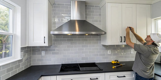 Man performing a vent hood repair above a kitchen stove.